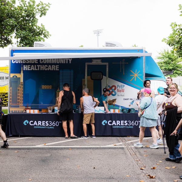 CARES 360 mobile health clinic serving community members at outdoor event.