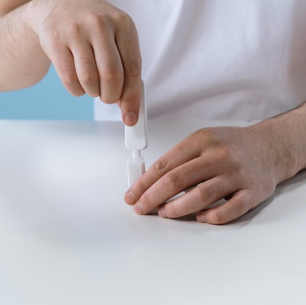 Photo illustration of man performing a rapid HIV test.